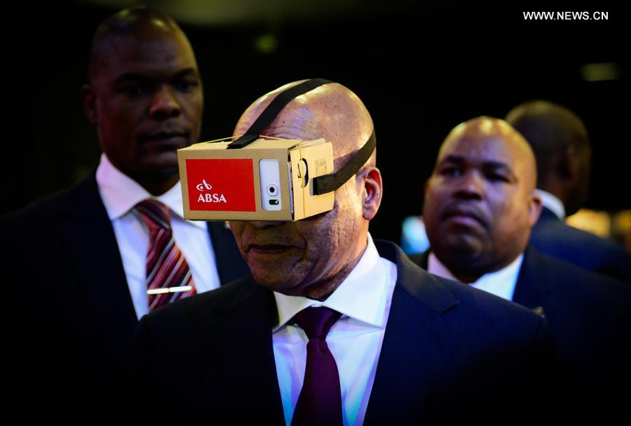 File photo taken on April 7, 2016 shows South African President Jacob Zuma tries a VR device provided by Amalgamated Banks of South Africa (ABSA) during the launch of the eChannel Pilot Project of the Department of Home Affairs at Gallagher Convention Center in Midrand, near Johannesburg, South Africa. 