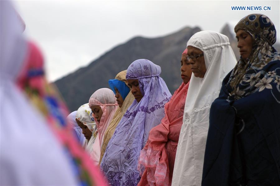 Indonesian Muslim women perform Eid al-Fitr praying near the Mount Sinabung at Guru Kinayan Village in Karo, North Sumatera, Indonesia, July 6, 2016.