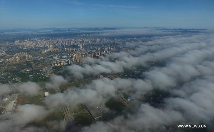 Photo taken on July 30, 2016 shows Qinzhou City enveloped by fog in south China's Guangxi Zhuang Autonomous Region. 