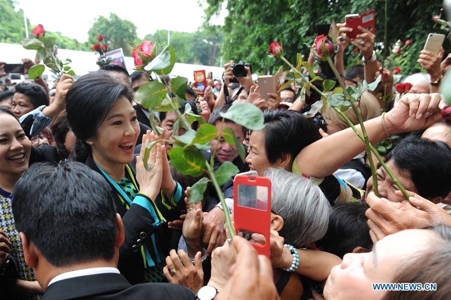 Thailand's former prime minister Yingluck Shinawatra shakes hands with supporters before a court hearing over a rice subsidy scheme in Bangkok, capital of Thailand, on Aug. 5, 2016.