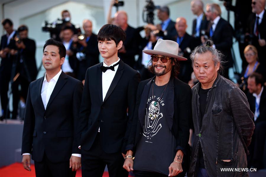 Korean director Kim Ki-duk (1st R) arrives at the red carpet to attend the opening ceremony of the 73rd Venice Film Festival in Venice, Italy, Aug. 31, 2016. (Xinhua/Jin Yu) 