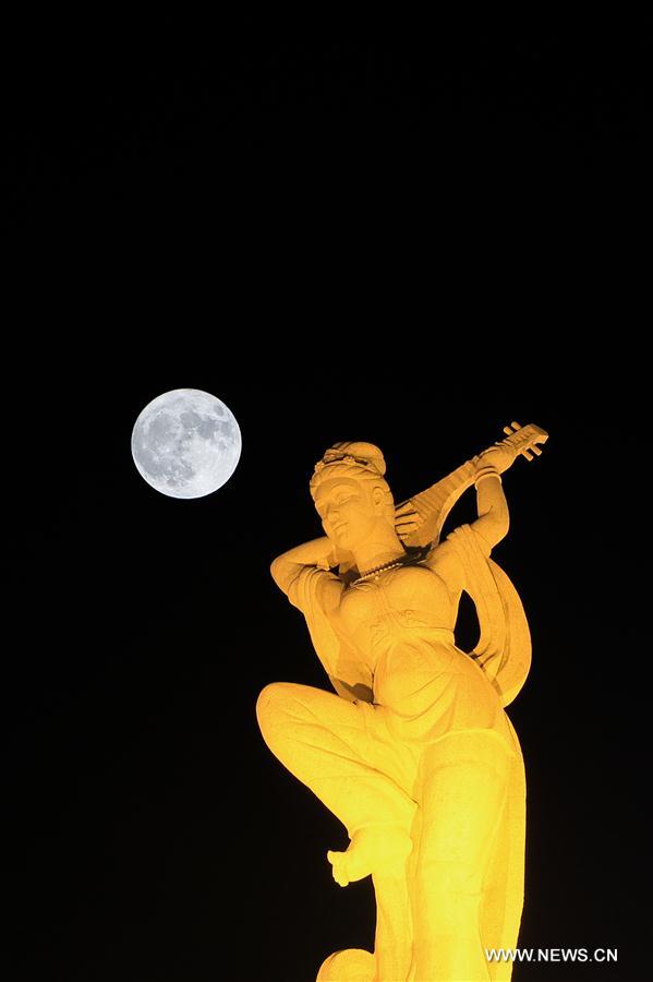 Double exposure photo taken on Nov. 14, 2016 shows the 'supermoon' over Dunhuang, northwest China's Gansu Province.