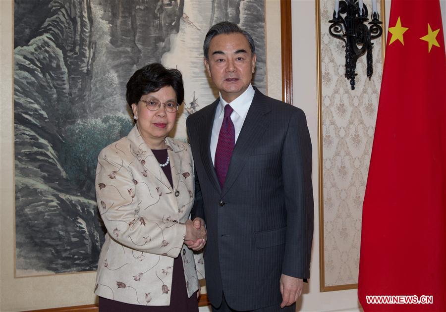 Chinese Foreign Minister Wang Yi (R) shakes hands with the World Health Organization (WHO) chief Margaret Chan Fung Fu-chun in Geneve, Switzerland, Dec. 11, 2016. (Xinhua/Xu Jinquan)