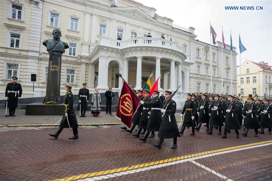 Lithuanian honour guards march to the site of the flag raising ceremony during the commemoration of the 99th anniversary of Independence Day of Lithuania in Vilnius, Lithuania, Feb. 16, 2017. 