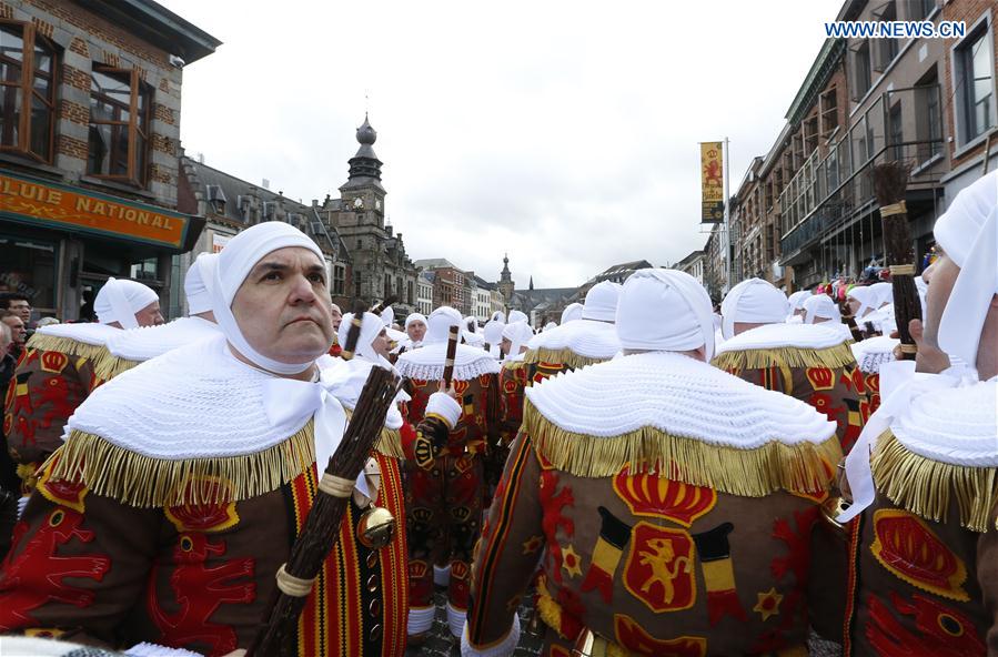 Local residents wearing costumes of 'Gilles' attend the parade of Mardi Gras (Shrove Tuesday), the last day of Carnival in Binche, some 60 km south to Brussels, capital of Belgium, Feb. 28, 2017. 