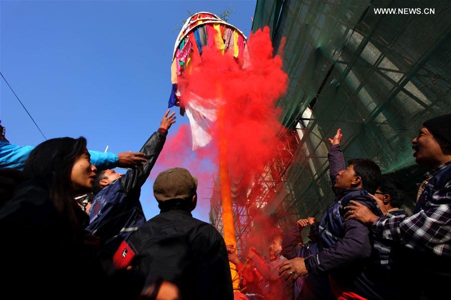 Nepalese people play with colored powders after hoisting a colorful pole known as 'chir' to mark the beginning of the week-long Holi festival in Kathmandu, Nepal, March 5, 2017. 