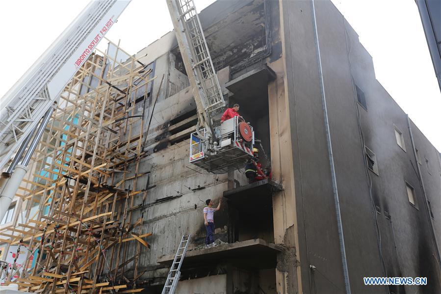 Firefighters check the damaged building of government of national salvation's TV channel which was set on fire by a group of gunmen in Tripoli, Libya, on March 15, 2017. Violent clashes erupted in the Libyan capital Tripoli since early Tuesday morning and lasted to Wednesday morning between rival militias, according to witnesses. The fighting is between two militias loyal to the two rival governments in Tripoli: the UN-backed government of national accord and the deposed government of national salvation that is attempting to take over the city and get back to power. (Xinhua/Hamza Turkia) 