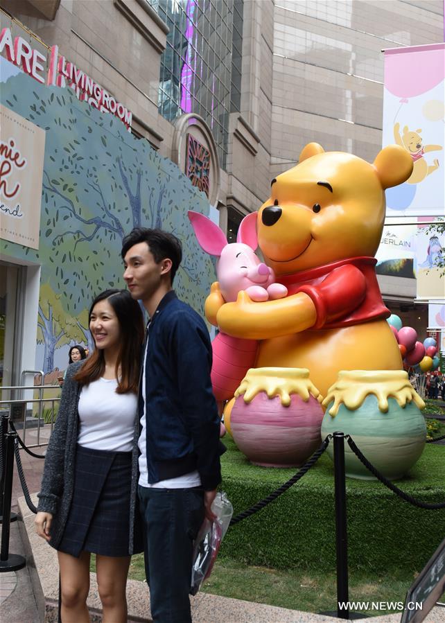 Tourists pose for photos during a Winnie the Pooh exhibition in Hong Kong, south China, March 29, 2017.