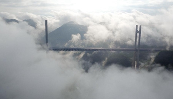 Scenery of cloud and mist blanketing Chinese river bridges