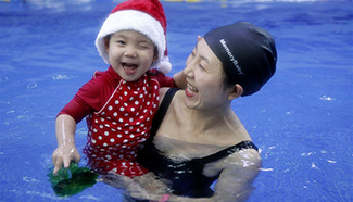 Babies attend Christmas swimming party in Beijing