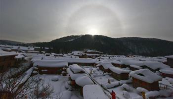 Solar halo appears over snow-covered scenic spot in NE China