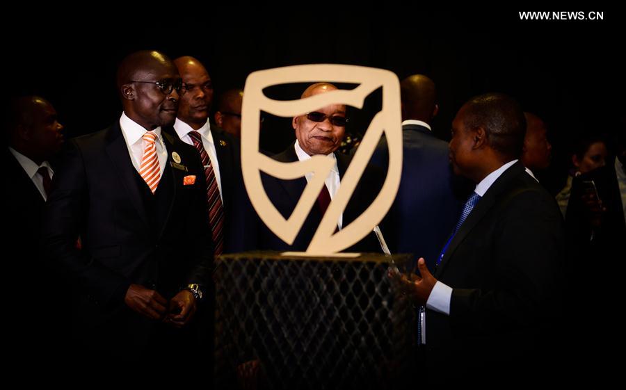 File photo taken on April 7, 2016 shows South African President Jacob Zuma (C) looks at the logo of Standard Bank during the launch of the eChannel Pilot Project of the Department of Home Affairs at Gallagher Convention Center in Midrand, near Johannesburg, South Africa. 