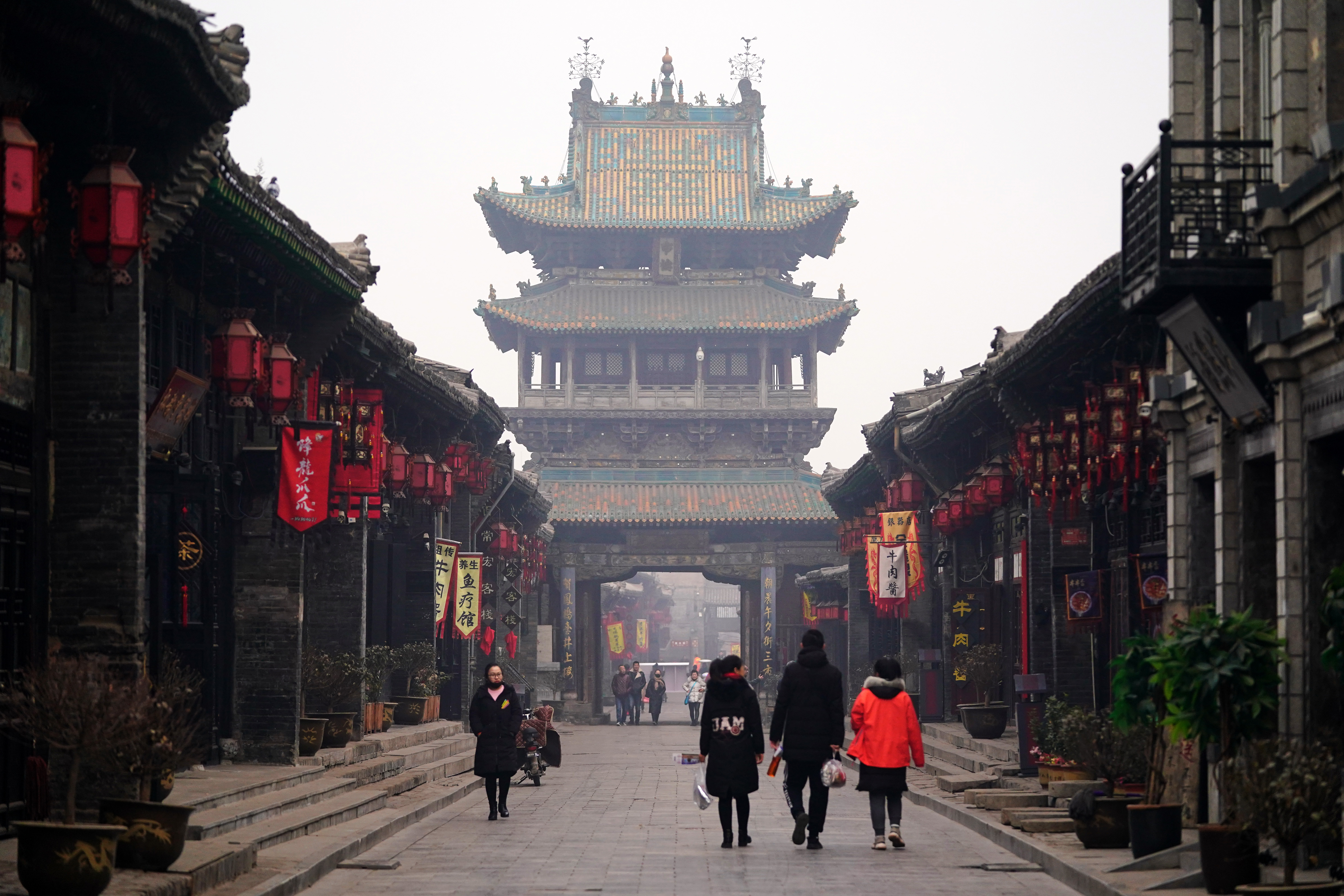 Tourists visit the ancient city of Pingyao in Jinzhong, north China's ...