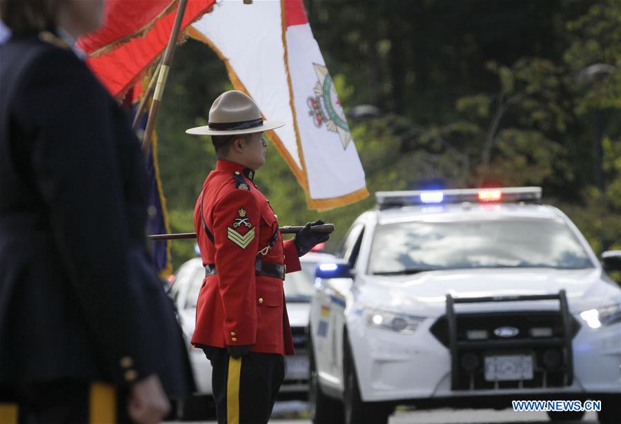 police vehicles pass by a royal canadian mounted police (rcmp)