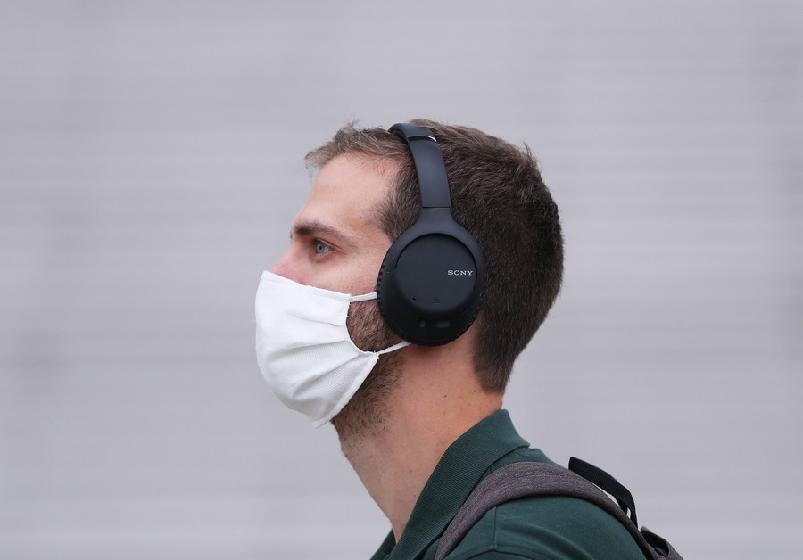 Customers wearing protective face masks strolling close from Chanel store  on the Champs Elysee avenue on May 11, 2020 in Paris, France. France began  a gradual easing of its lockdown measures and