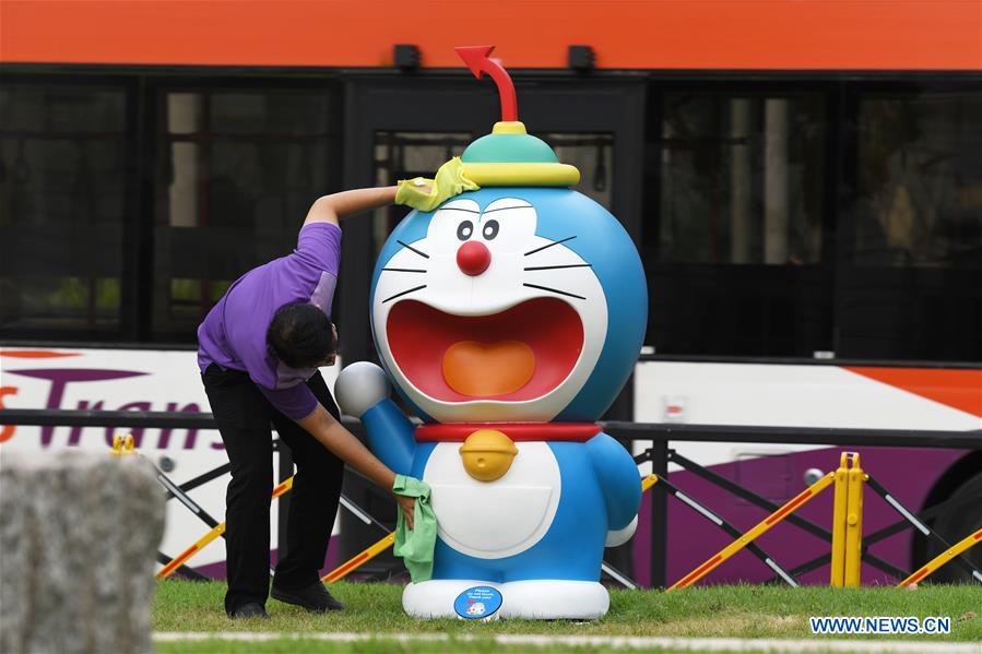 A pedestrian walks past Doraemon figures on display in the window of  News Photo - Getty Images