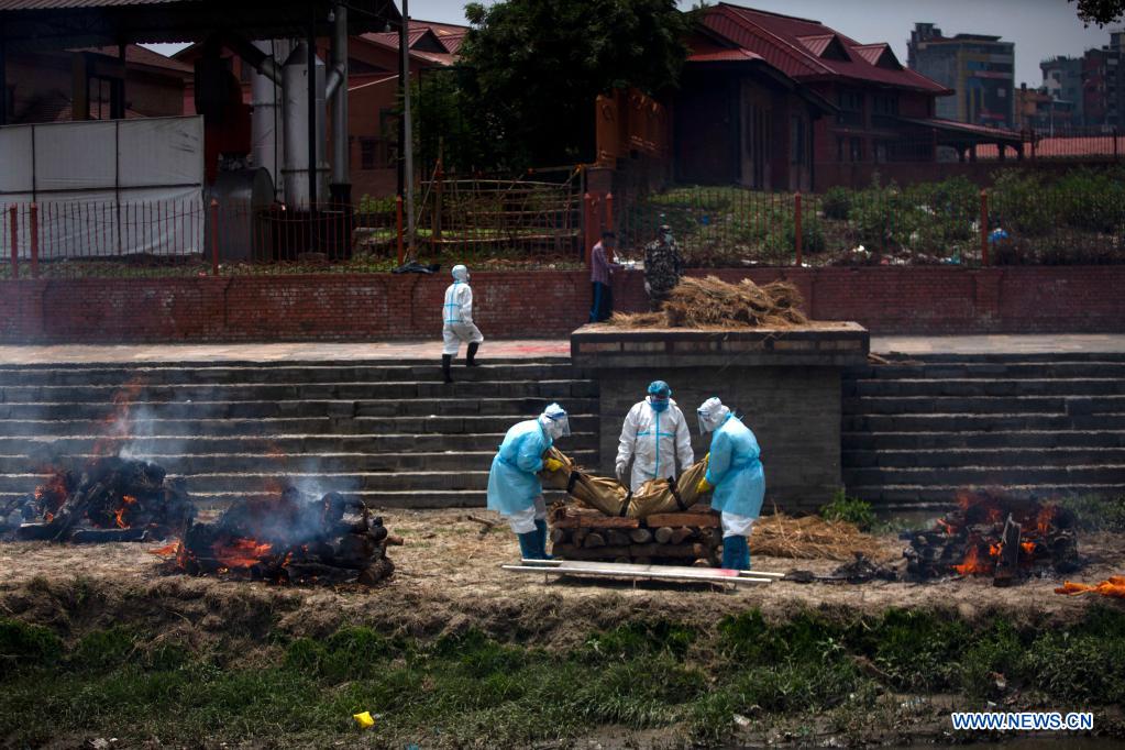workers cremate victims from covid-19 at pashupatinath temple