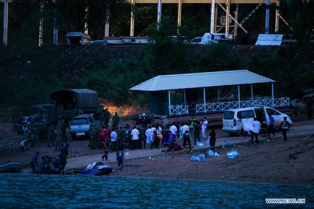 rescuers work near the yacht capsizing site, on the shore of