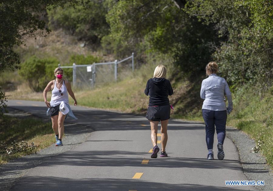 people walk along trail at park in san mateo county, u.s.