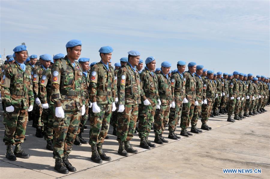 Cambodia's Defense Minister Gen. Tea Banh (2nd L front) and Claire Van der Vaeren (1st L), resident coordinator of the United Nations Development Program in Cambodia, inspect troops at the Military Airbase in Phnom Penh, Cambodia, June 9, 2016. 