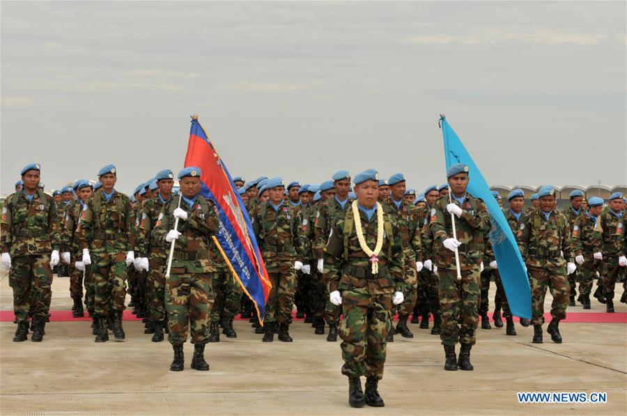 Cambodia's Defense Minister Gen. Tea Banh (2nd L front) and Claire Van der Vaeren (1st L), resident coordinator of the United Nations Development Program in Cambodia, inspect troops at the Military Airbase in Phnom Penh, Cambodia, June 9, 2016. 