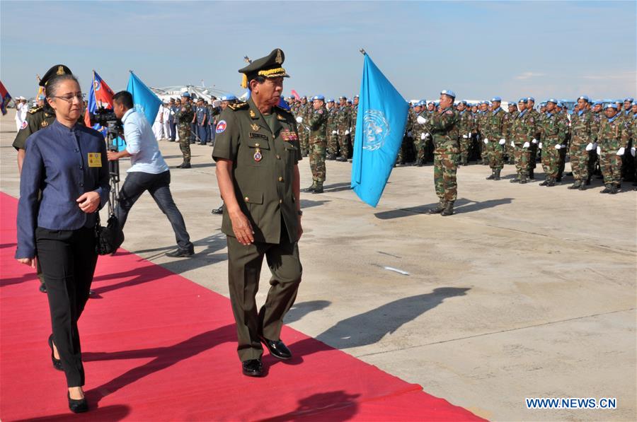 Cambodia's Defense Minister Gen. Tea Banh (2nd L front) and Claire Van der Vaeren (1st L), resident coordinator of the United Nations Development Program in Cambodia, inspect troops at the Military Airbase in Phnom Penh, Cambodia, June 9, 2016. 