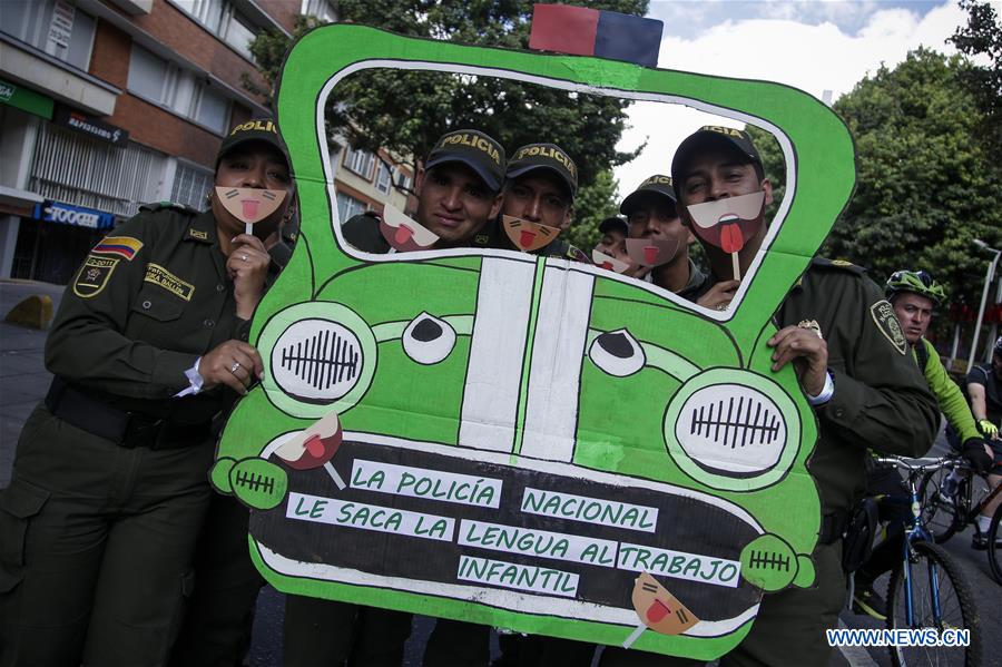  A girl poses with a mask during the campaign 'Stick your Tongue Out to Child Labour' on the World Day against Child Labour in Bogota, Colombia, on June 12, 2016.