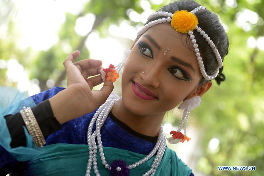 A Bangladeshi artist dances during an event marking Pahela Ashar, the first day of the rainy season, in Dhaka, Bangladesh, June 15, 2016.