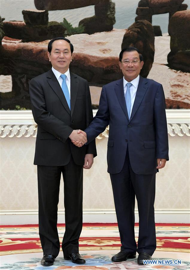 Cambodian Senate President Samdech Say Chhum (R) walks with visiting Vietnamese President Tran Dai Quang in Phnom Penh, Cambodia, on June 15, 2016. 