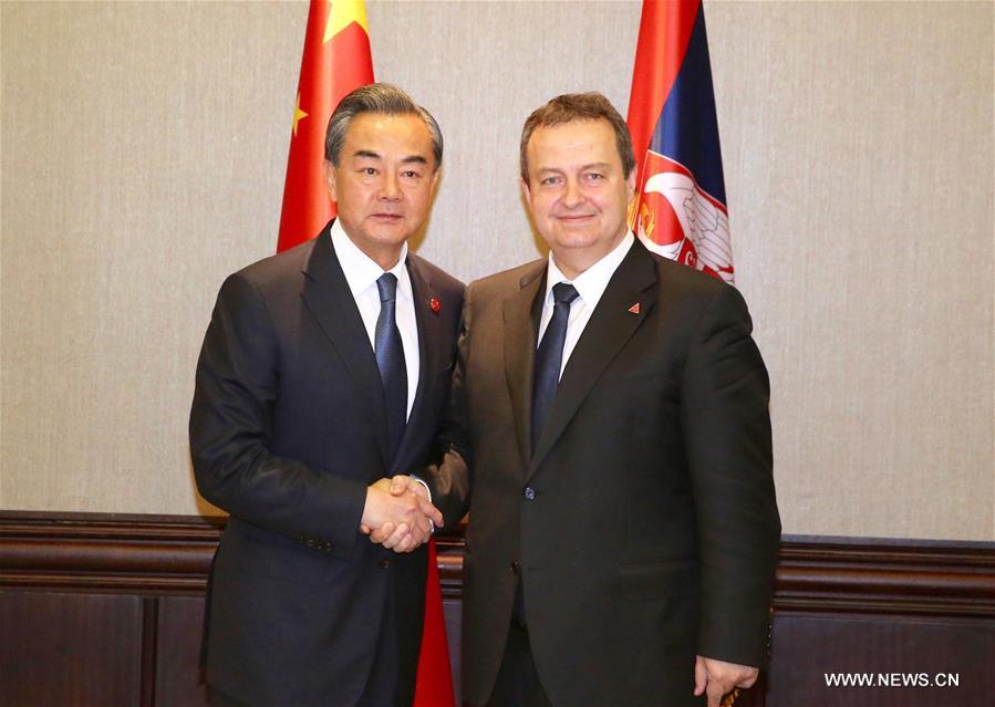 Chinese Foreign Minister Wang Yi (L) shakes hands with Ivica Dacic, Serbia's first deputy prime minister and foreign minister, in Belgrade, Serbia, June 17, 2016