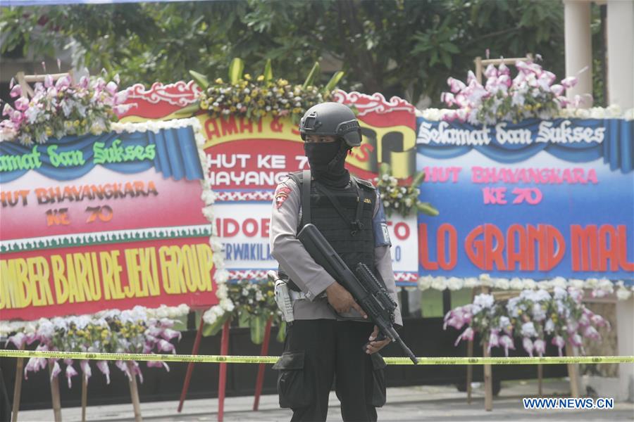 A policeman stands guard at the site of a suicide bombing at a police station in Solo, Central Java, Indonesia, July 5, 2016.