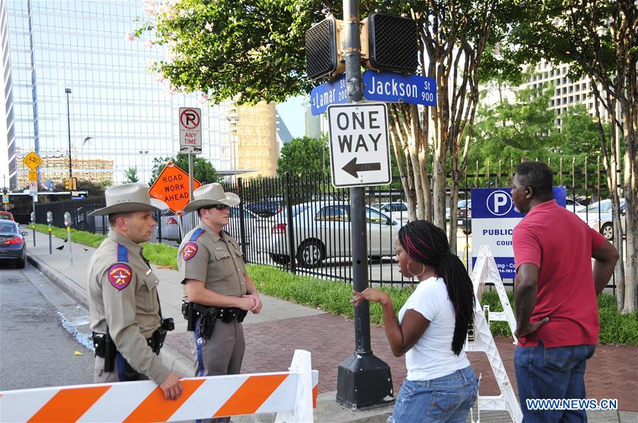 An FBI detective works at the scene of shooting of police personnel in Dallas, the United States, July 8, 2016. 