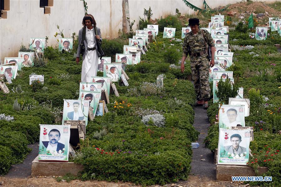 A man walks among graves of Houthi fighters killed in airstrikes by the Saudi Arabia-led coalition, at a cemetry in Sanaa, capital of Yemen, on Aug. 7, 2016.
