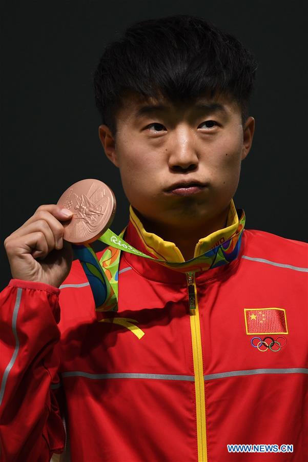 Bronze medalist China's Li Yuehong attends the awarding ceremony for the men's 25m rapid fire pistol final of Shooting at the 2016 Rio Olympic Games in Rio de Janeiro, Brazil, on Aug. 13, 2016.