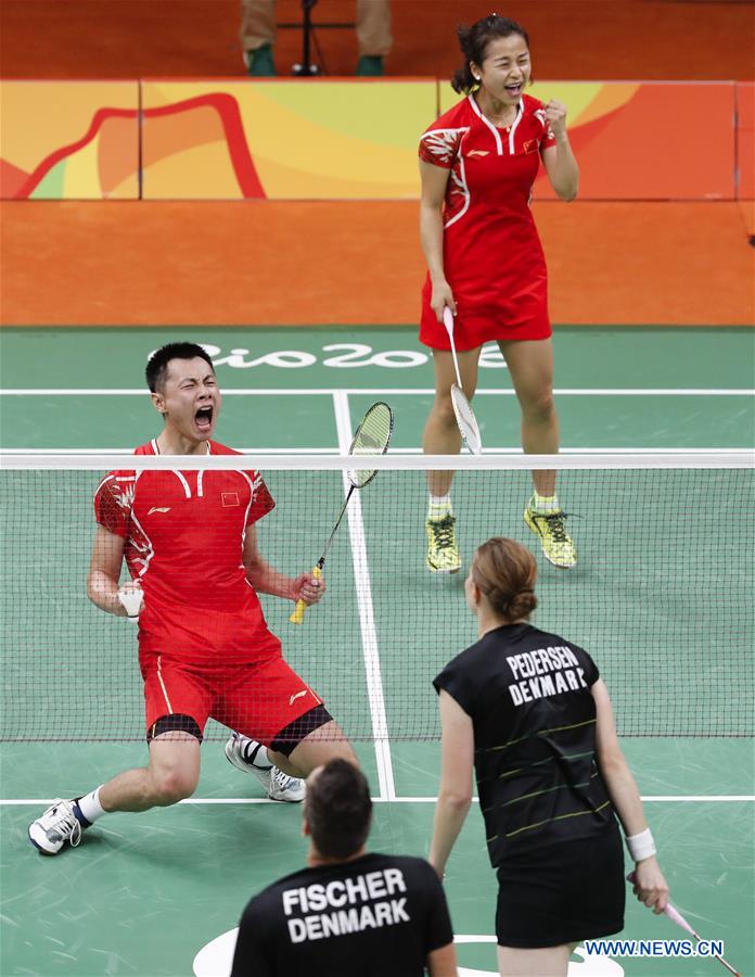 China's Xu Chen (L) and Ma Jin react during a mixed doubles group play stage match of Badminton against Denmark's Joachim Fischer Nielsen and Christinna Pedersen at the 2016 Rio Olympic Games in Rio de Janeiro, Brazil, on Aug. 13, 2016. 