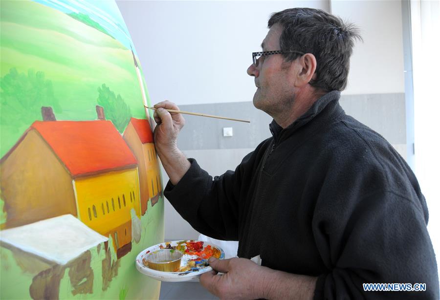 A local painter works on a large Easter egg in Koprivnica, Croatia, Feb. 28, 2017. Nearly 70 Easter eggs painted in Croatian Naive art style by the painters of Koprivnica have been displayed in many cities around the world during Easter in last 10 years. 