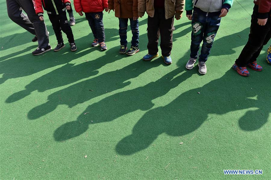 Children stand on the playground during an outdoor training at a service center of the Lingxing community in Taiyuan, capital of north China's Shanxi Province, March 28, 2017. Established in 2010, the service center has accommodated over 60 children with autism. A total of 29 teachers take part in the rehabilitation program to help these children. April 2 marks the World Autism Awareness Day. (Xinhua/Zhan Yan) 
