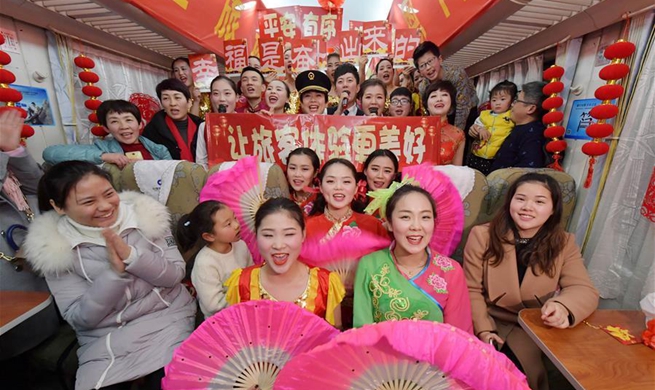 Attendants perform for passengers on train to celebrate Spring Festival