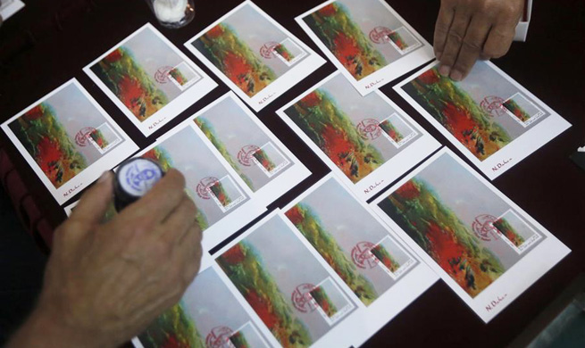 Stamps and postcards of Lebanese artist Daher's painting "Sunset" launched in Beirut