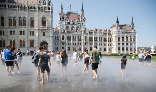 People cool off through sprays in downtown Budapest, Hungary