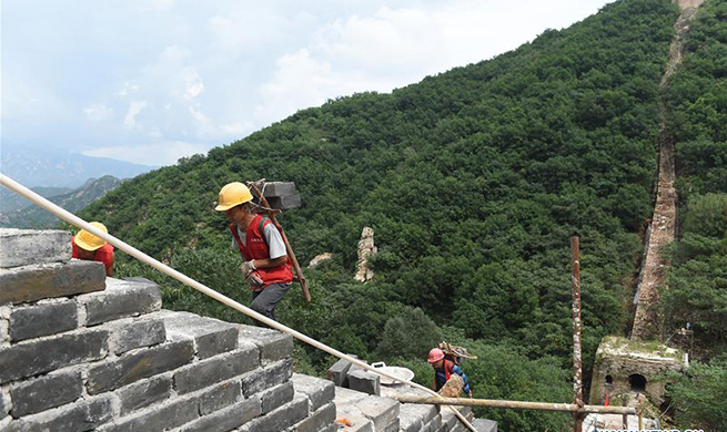 Workers repair section of Great Wall north of Donggou Village in Beijing