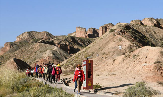 Tourists visit Danxia landform at Binggou scenic area in China's Gansu