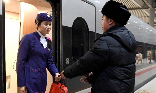 Couple working in rail dedicated to work during Spring Festival travel rush