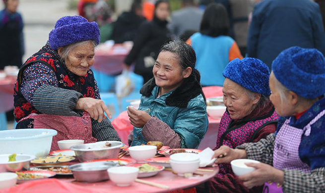 Residents of poverty-alleviation settlement enjoy meal to greet upcoming Spring Festival in China's Guizhou