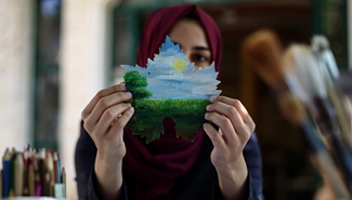 Feature: Gazan artist draws on grape leaves to overcome psychological stress