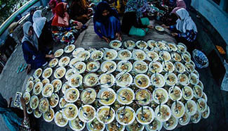 Indonesian muslims eat porridge for Iftar during Ramadan