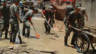 Soldiers clean up mud on roads in Yongtai after typhoon hits Fujian