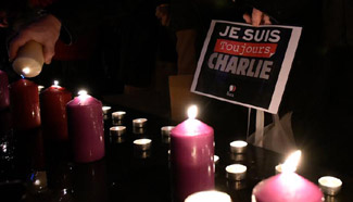 People mourn victims of terrorist attack against Charlie Hebdo in 2015