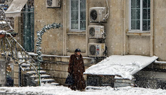 Pedestrian walks on snow covered street of Baku, Azerbaijan