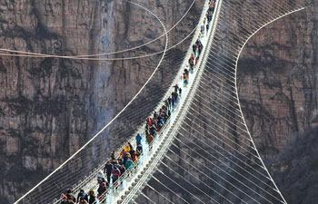 Glass suspension bridge opens to public in north China